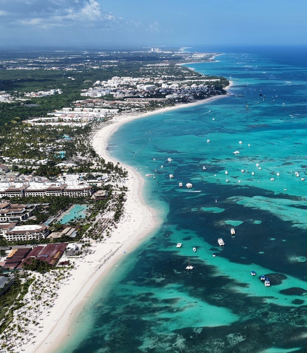Punta Cana skyline with resorts along the beach, illustrating how location shapes the travel experience.