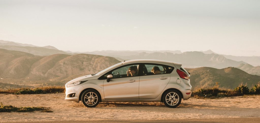 Family in a car driving through the hills of Spain