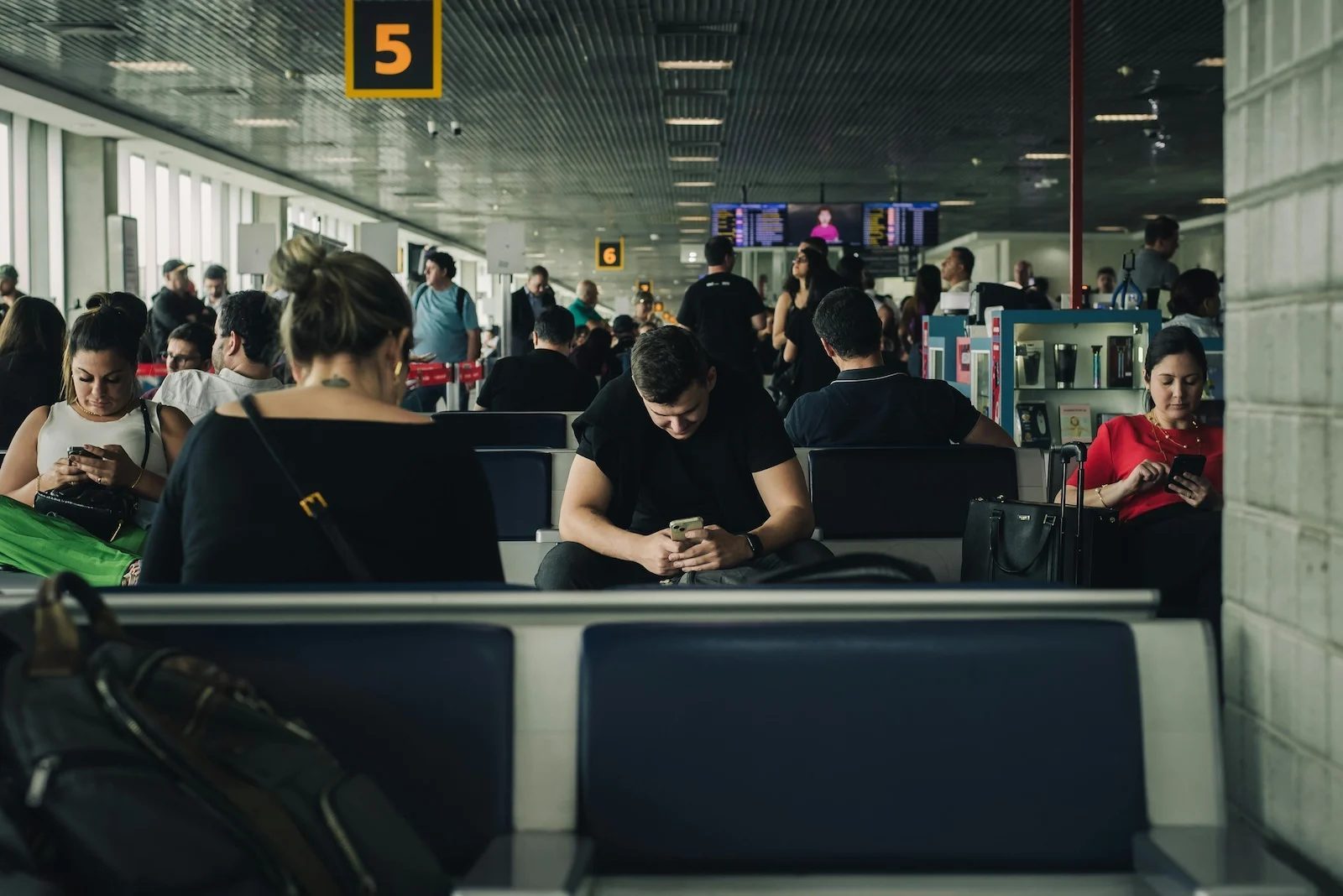 Passengers waiting in an airport terminal during a layover