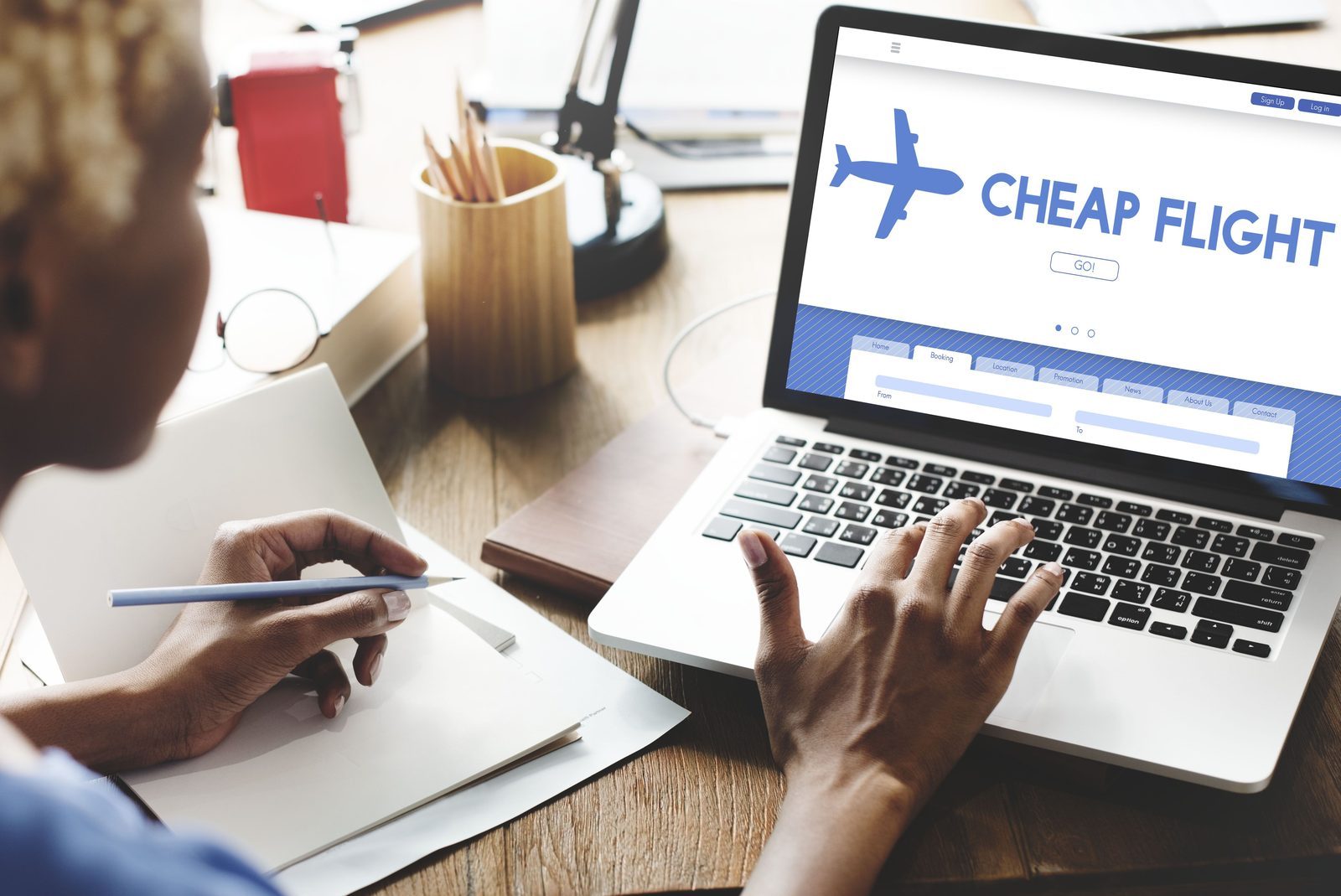 Traveler searching for cheap last-minute flights on a laptop