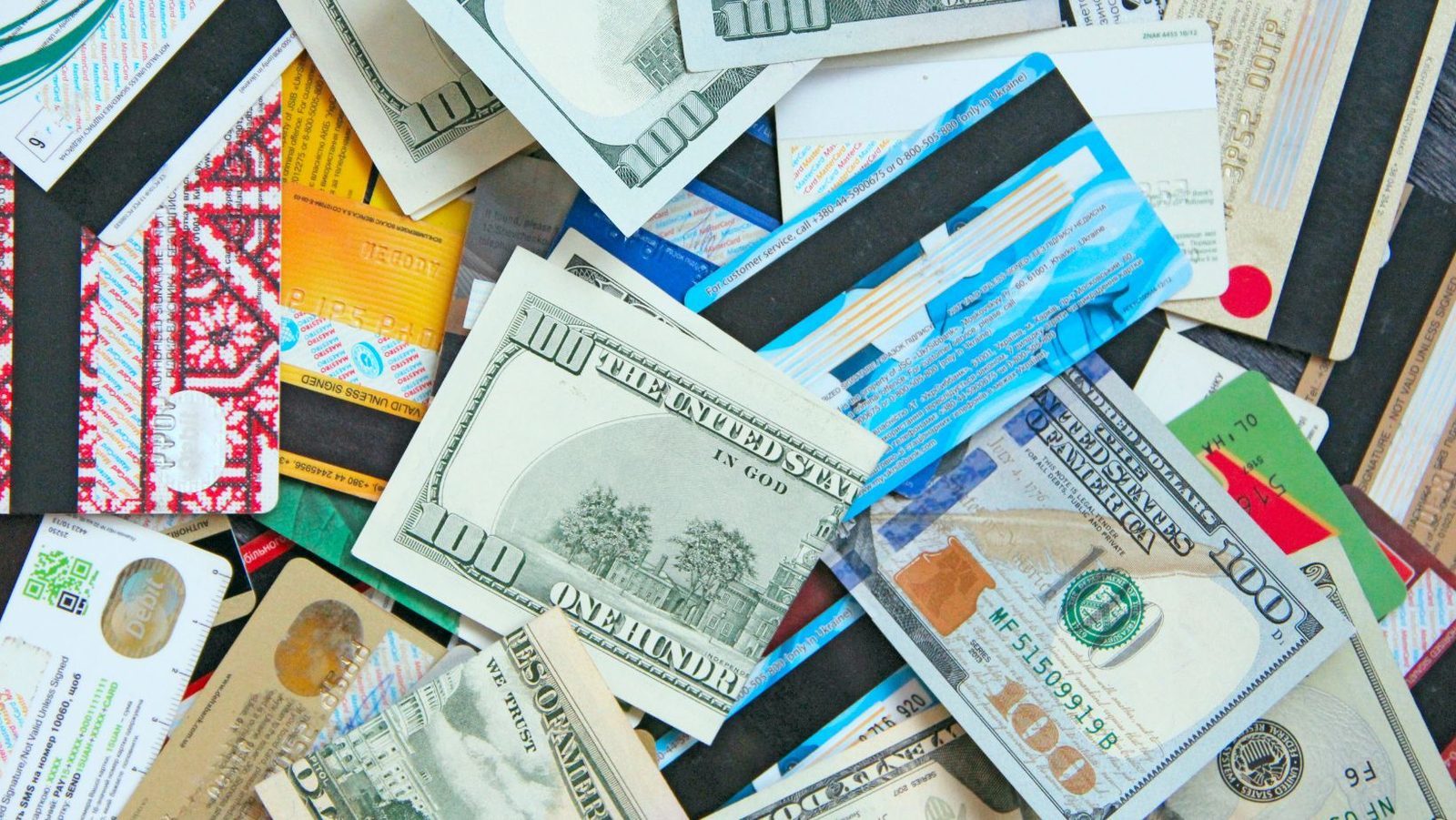 Traveler organizing a mix of cards and cash before an international trip
