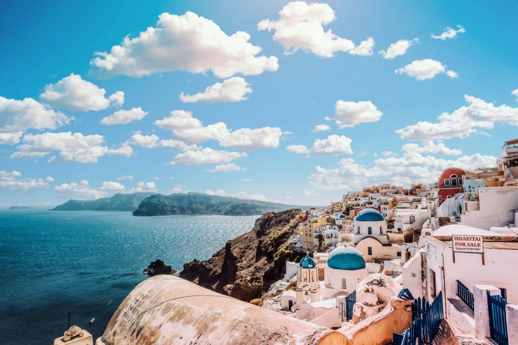 View of Santorini's blue-domed buildings under a vibrant sky, symbolizing a well-planned, stress-free trip