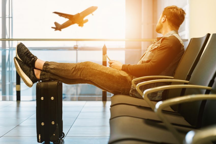 Airport interior with travelers and departure boards