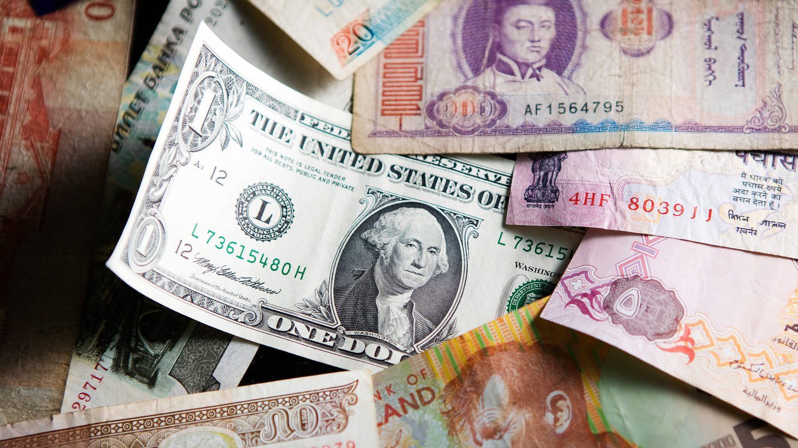 Various international banknotes, including a U.S. dollar, highlighting global currencies and emergency travel cash.