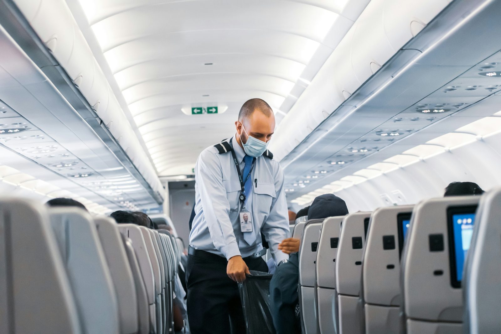 airline passenger standing in aisle during flight
