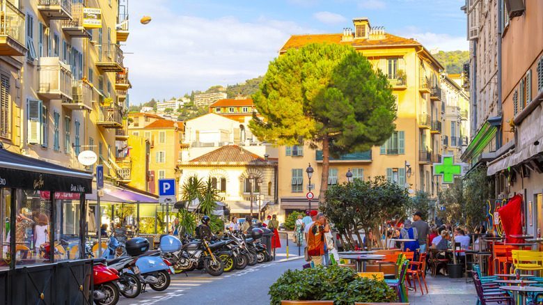 A colorful section of Vieux Nice, the historic old town, full of sidewalk cafes and shops in the Mediterranean seaside city of Nice, France