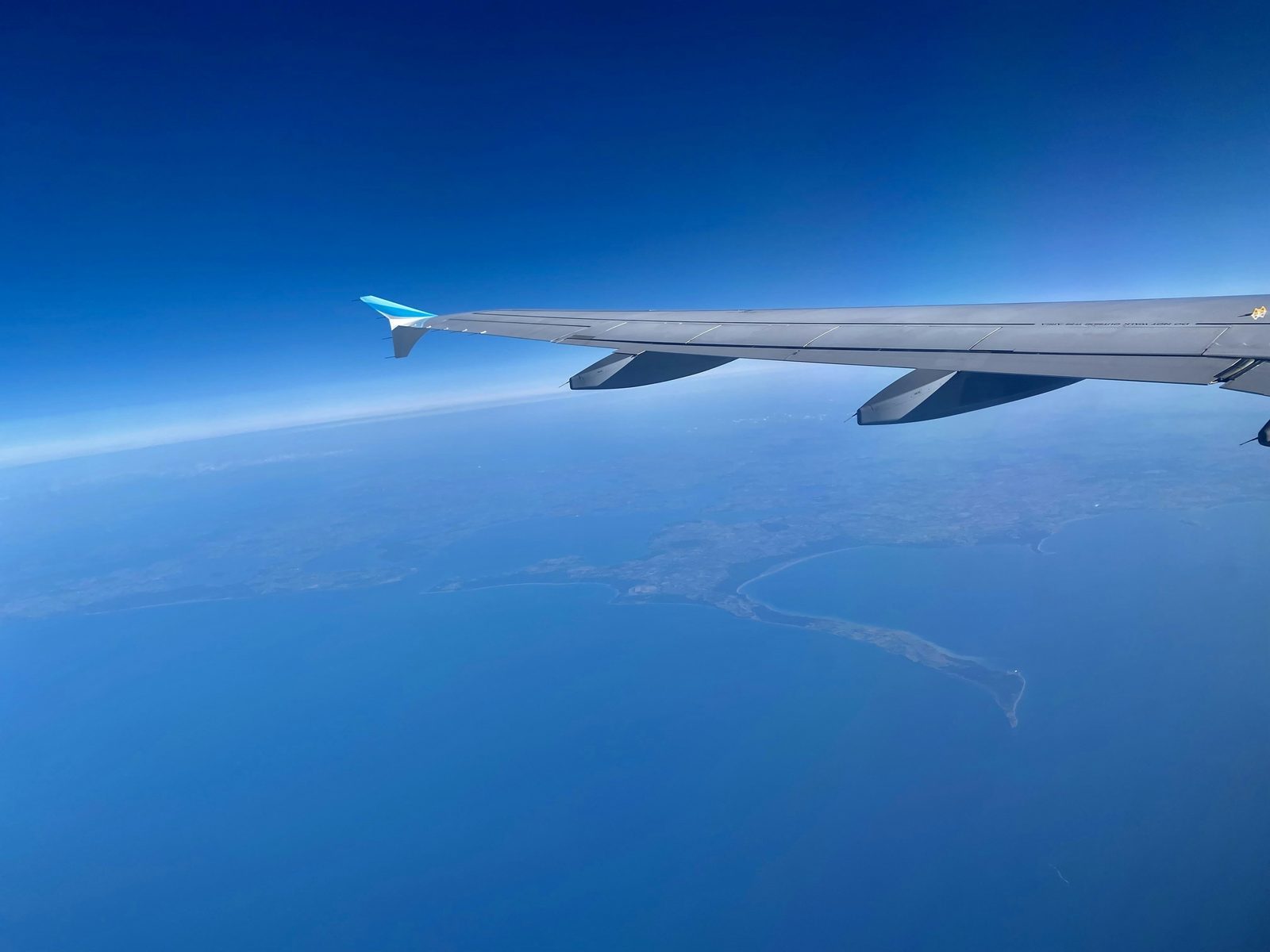 Airplane flying over the ocean, symbolizing complex multi-leg international journeys