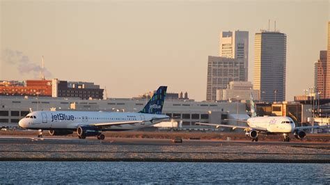 traveler arriving at Boston Logan Airport at sunrise after a red eye flight