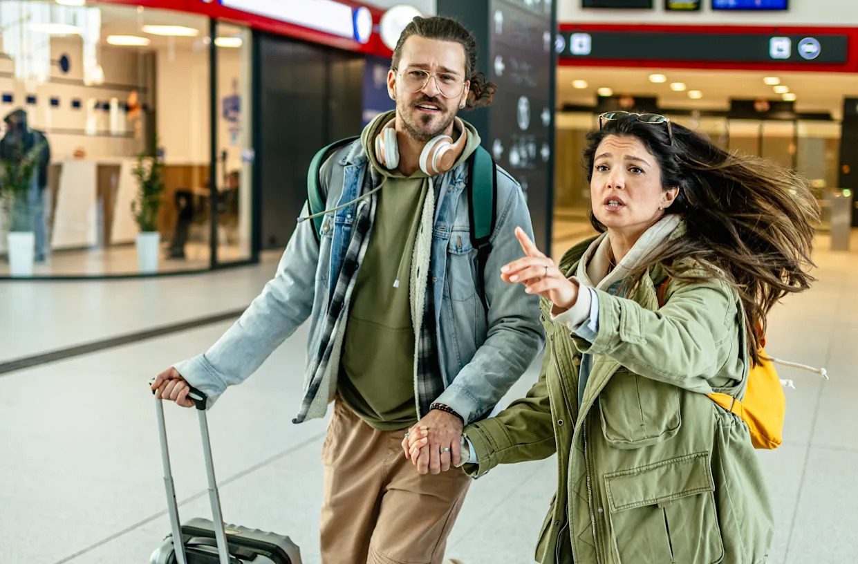 Traveler checking flight information on a phone to manage layover time