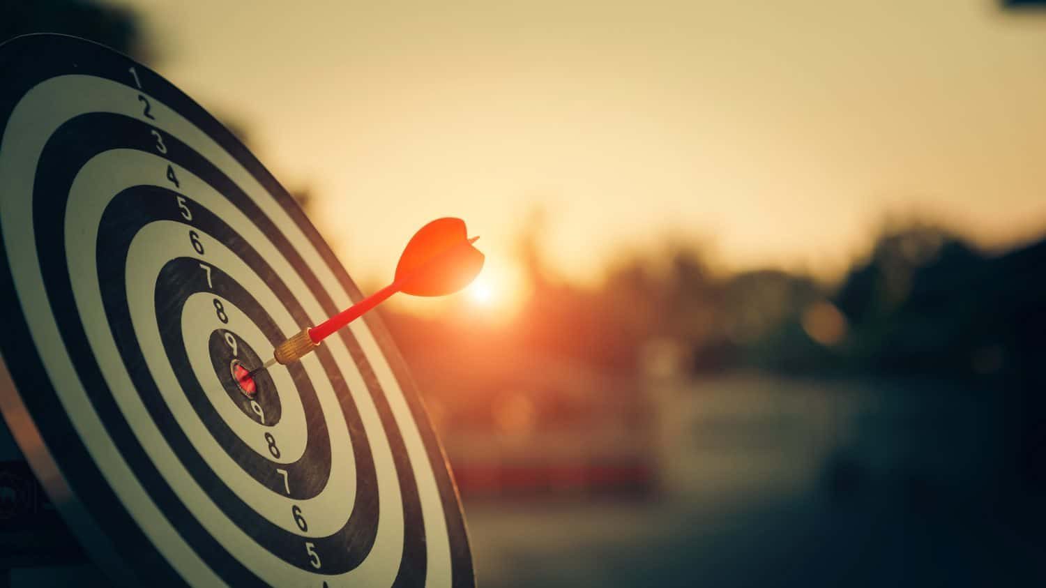 Dart hitting the center of a target, symbolizing hitting financial goals