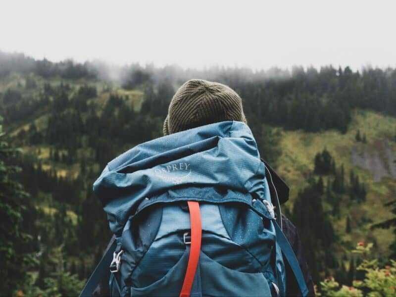 Backpack ready for adventure in the wilderness, symbolizing the mindset and preparation behind budget backpacking.