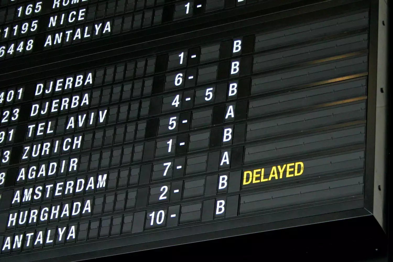 Airport departure board in terminal with flight information
