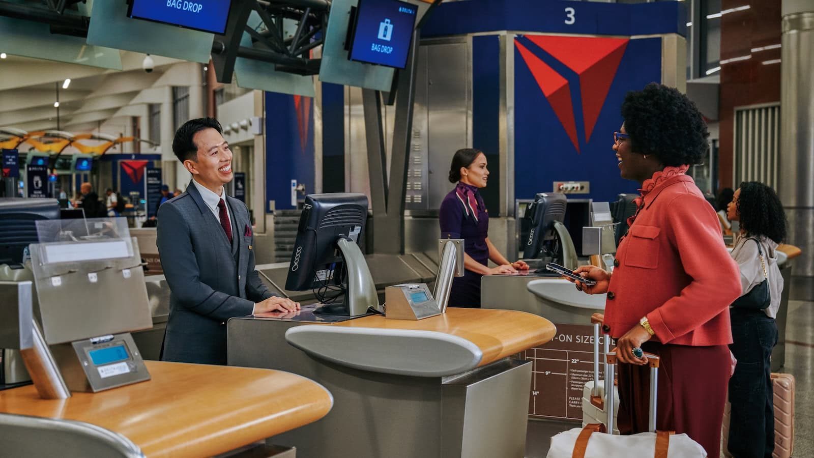 Traveler at an airport gate checking flight change options on a phone