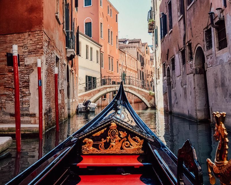 Venice's canals with historic buildings, hinting at the high cost of staying in the city.