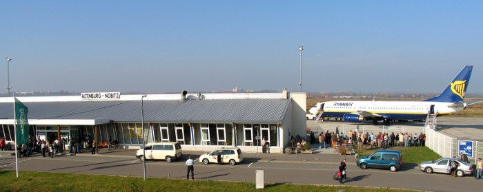 Remote secondary airport surrounded by fields, far from the main city