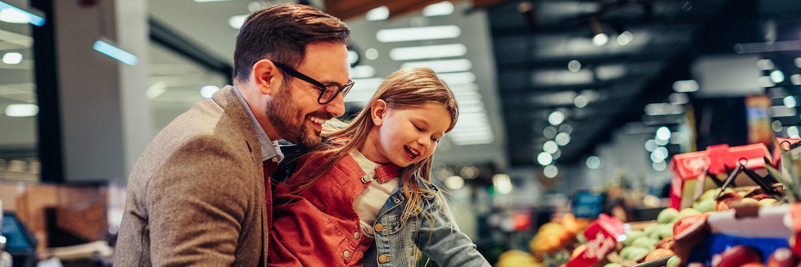 Parent and child shopping for groceries, a budget-friendly way to eat on recovery days