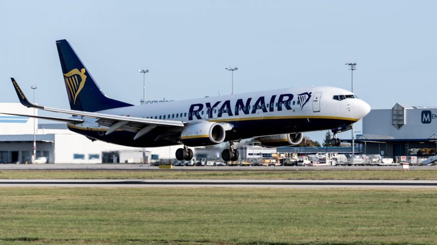 Ryanair Boeing 737 touching down at Prague Airport on a clear day.