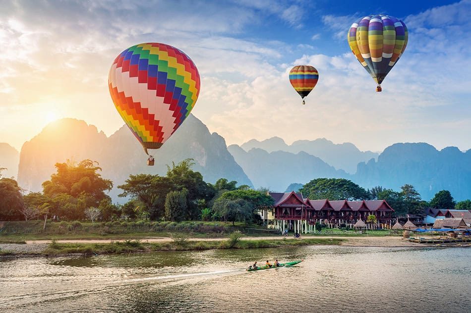 Travelers enjoying budget-friendly adventure activities in Vang Vieng, Laos