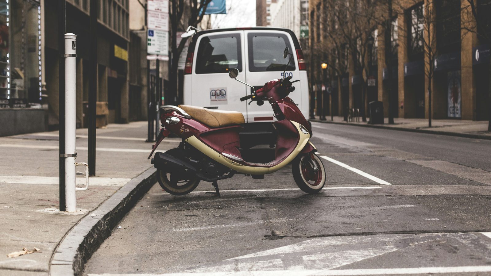 Motor scooter parked near public transport area