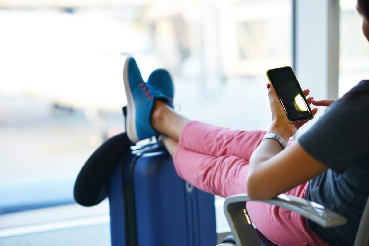 Traveler waiting with luggage during a long layover in an airport