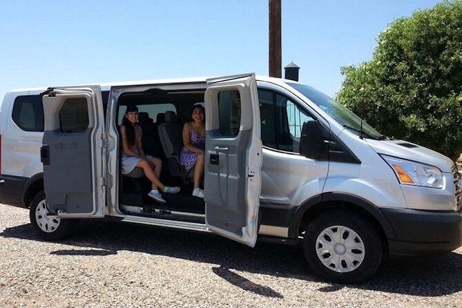 Shuttle service vehicle waiting outside an airport terminal
