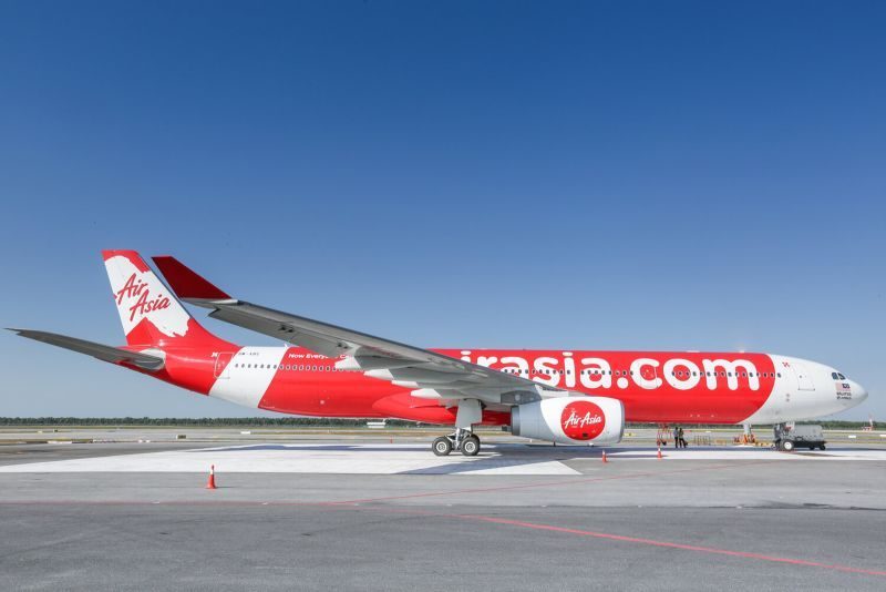 Long-haul low-cost carrier aircraft on the tarmac, representing budget international travel