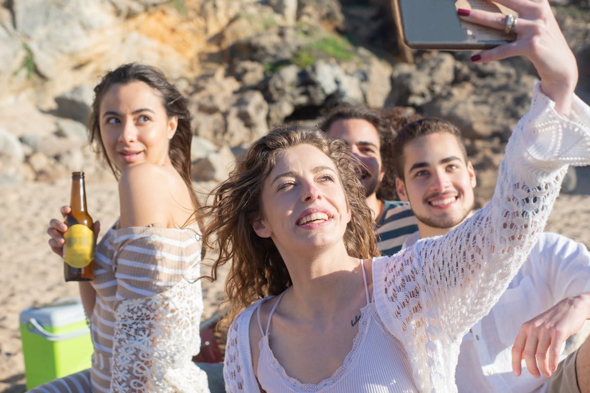 Group of friends taking a selfie together during a sunny beach vacation
