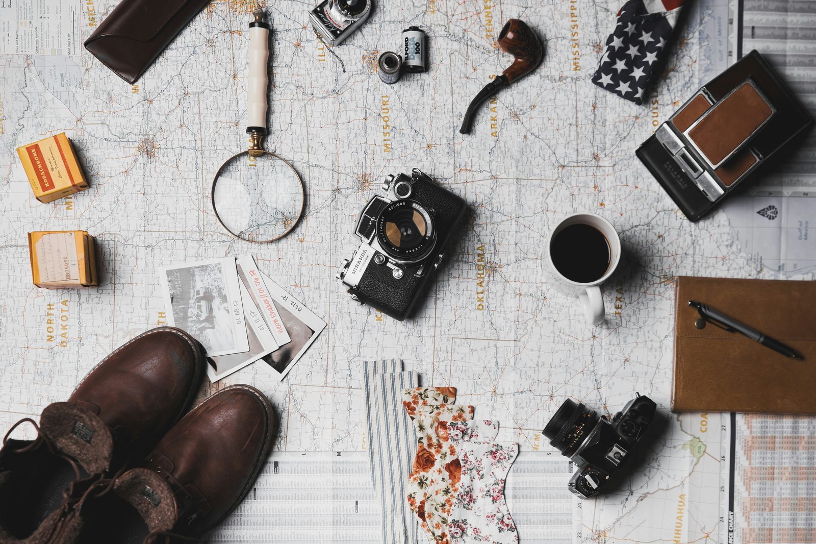 Travel planning essentials on a table, symbolizing thoughtful preparation before spontaneous adventures.