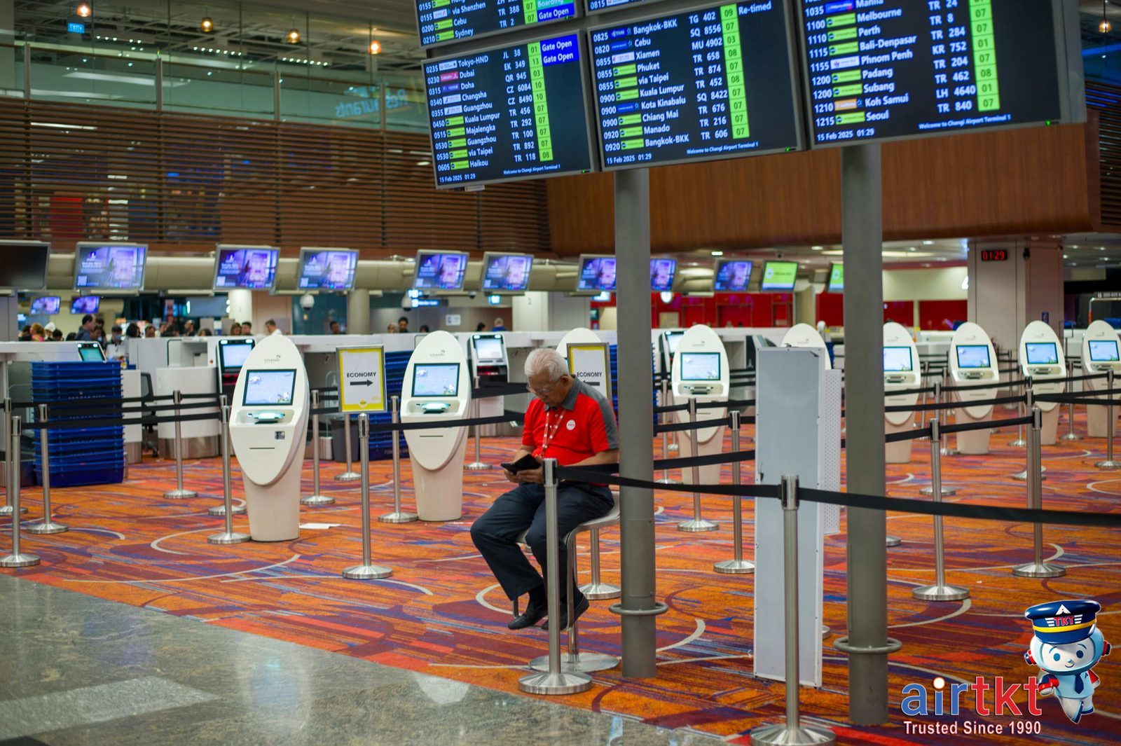 Traveler checking flight options for multiple airports in a busy terminal