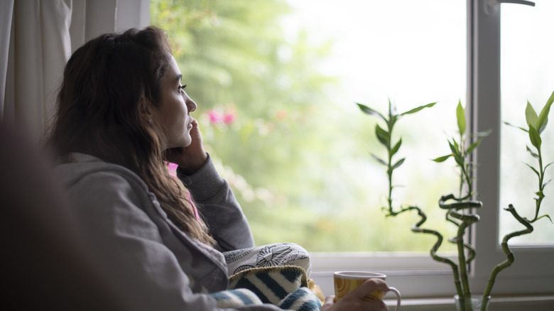 A sad woman looking out of the window