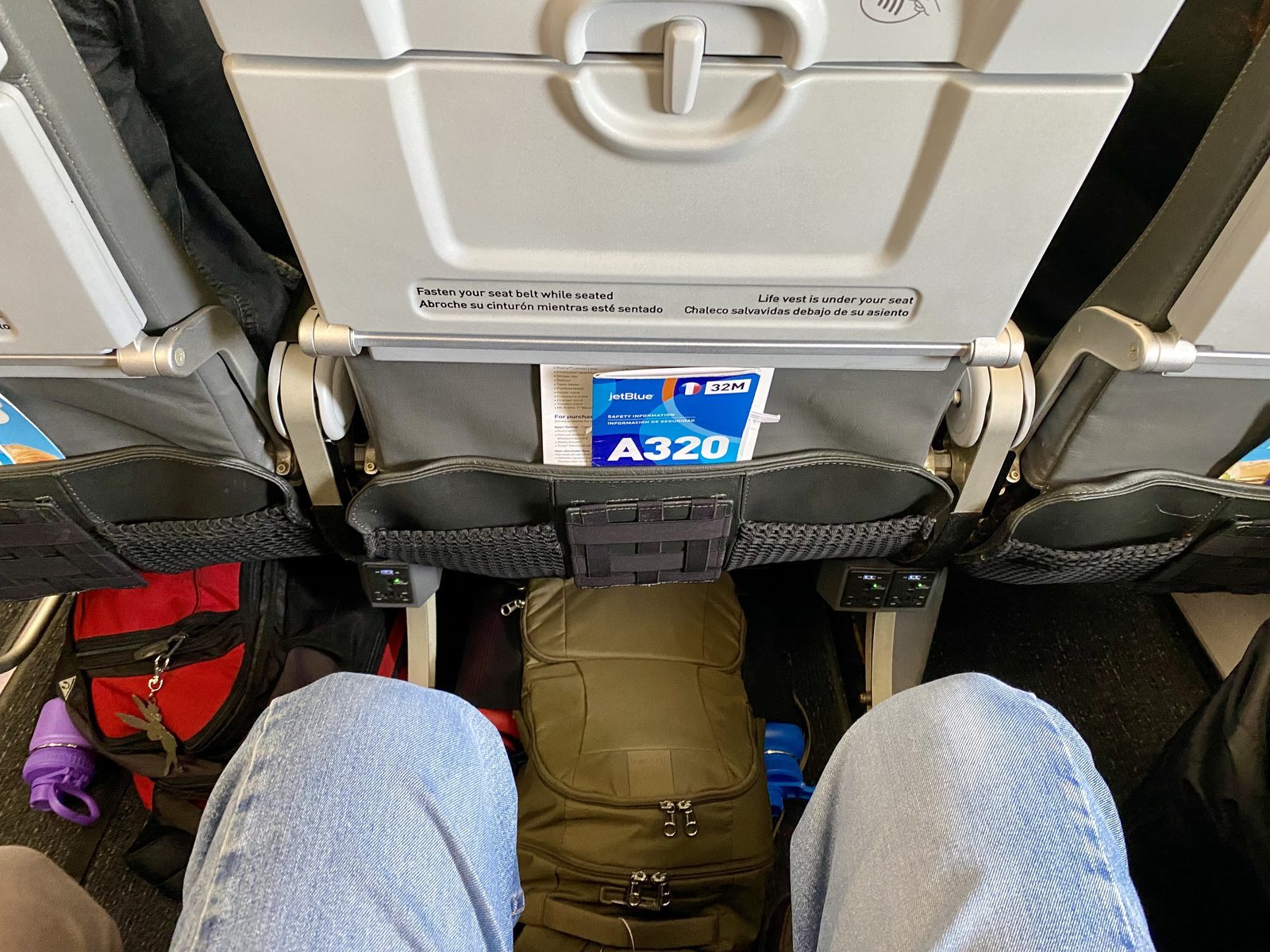 extra legroom on a JetBlue flight, showing lots of space between legs and the seat in front