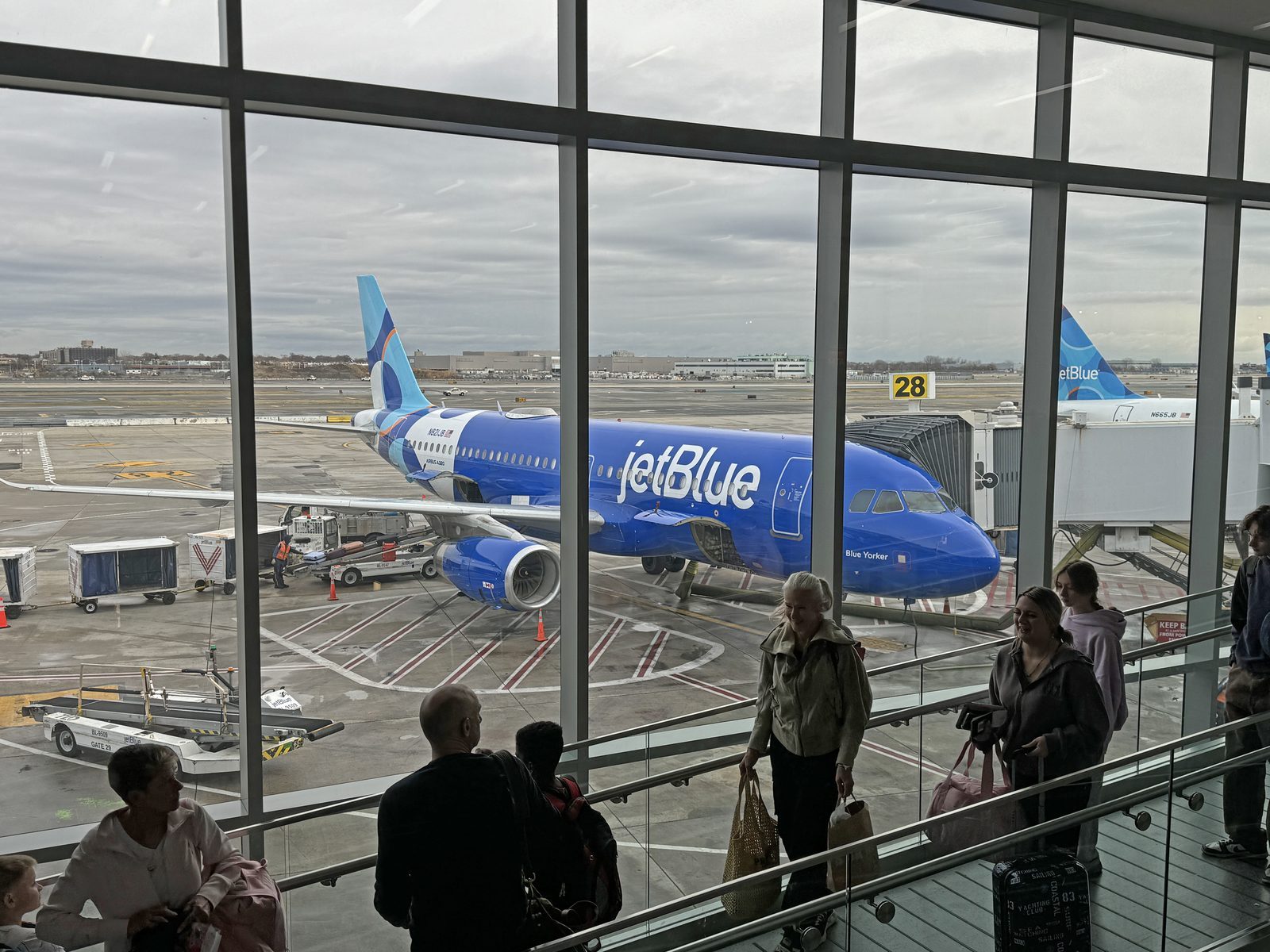 Crowded airport terminal with passengers waiting during delays