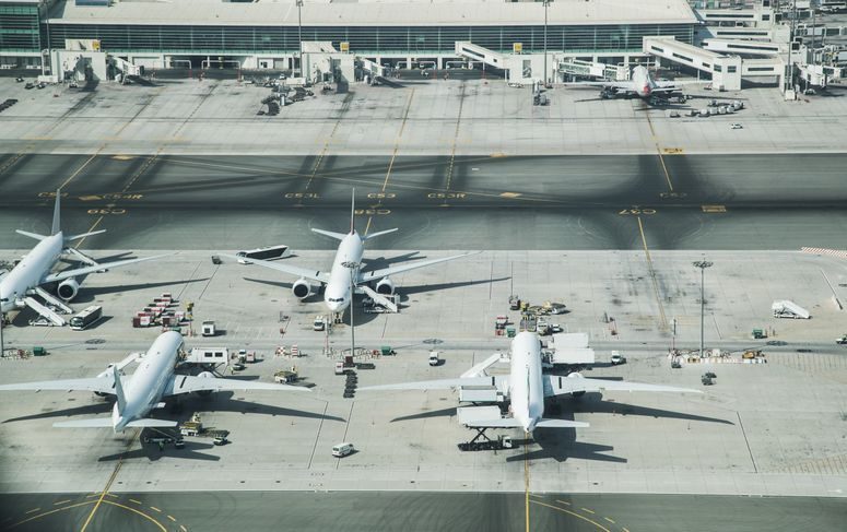 Airplane on the tarmac at an airport.